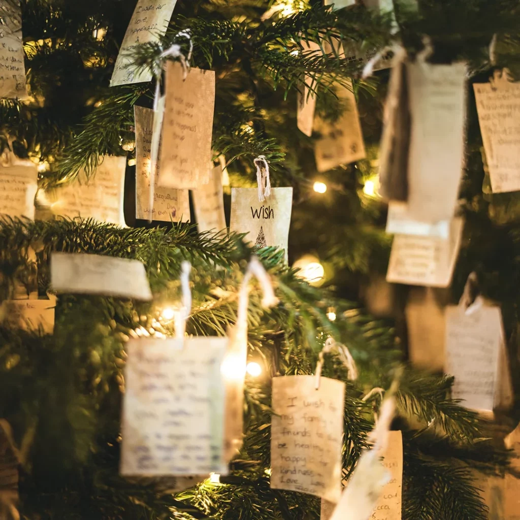 Tree adorned with handwritten wish tags