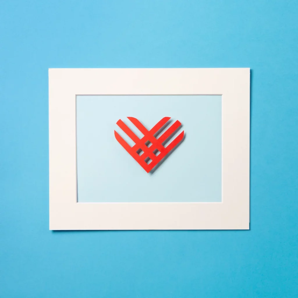 Red heart art on blue background