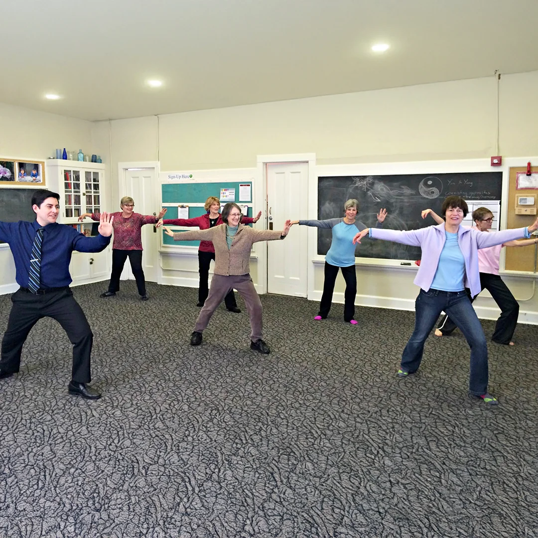 Group of people practicing movements indoors
