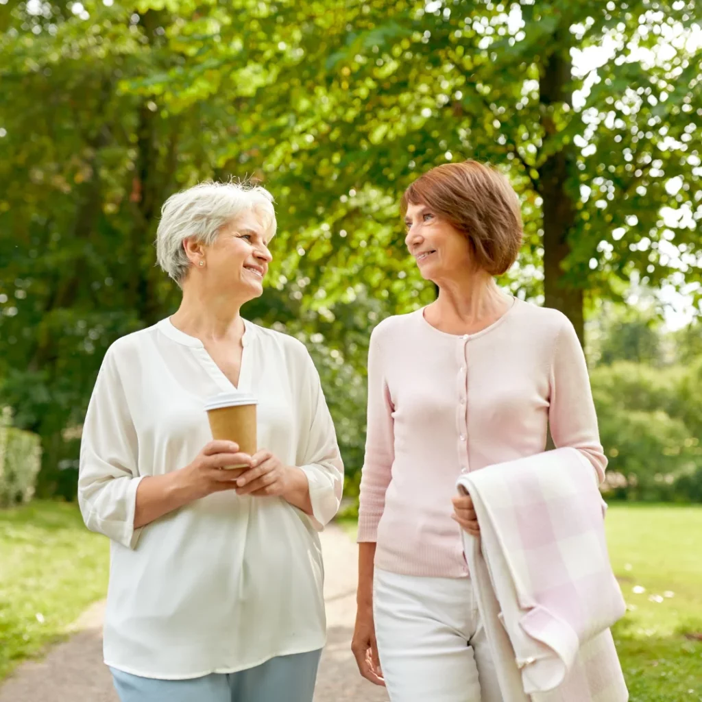 Two women walking and chatting outdoors.