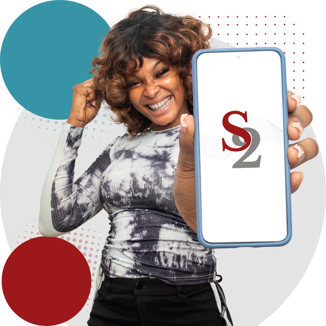 Smiling woman with curly hair holding a phone displaying the S2 logo.