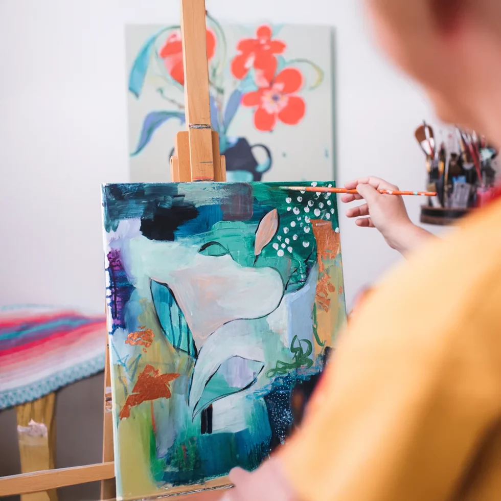 Artist painting abstract artwork on canvas