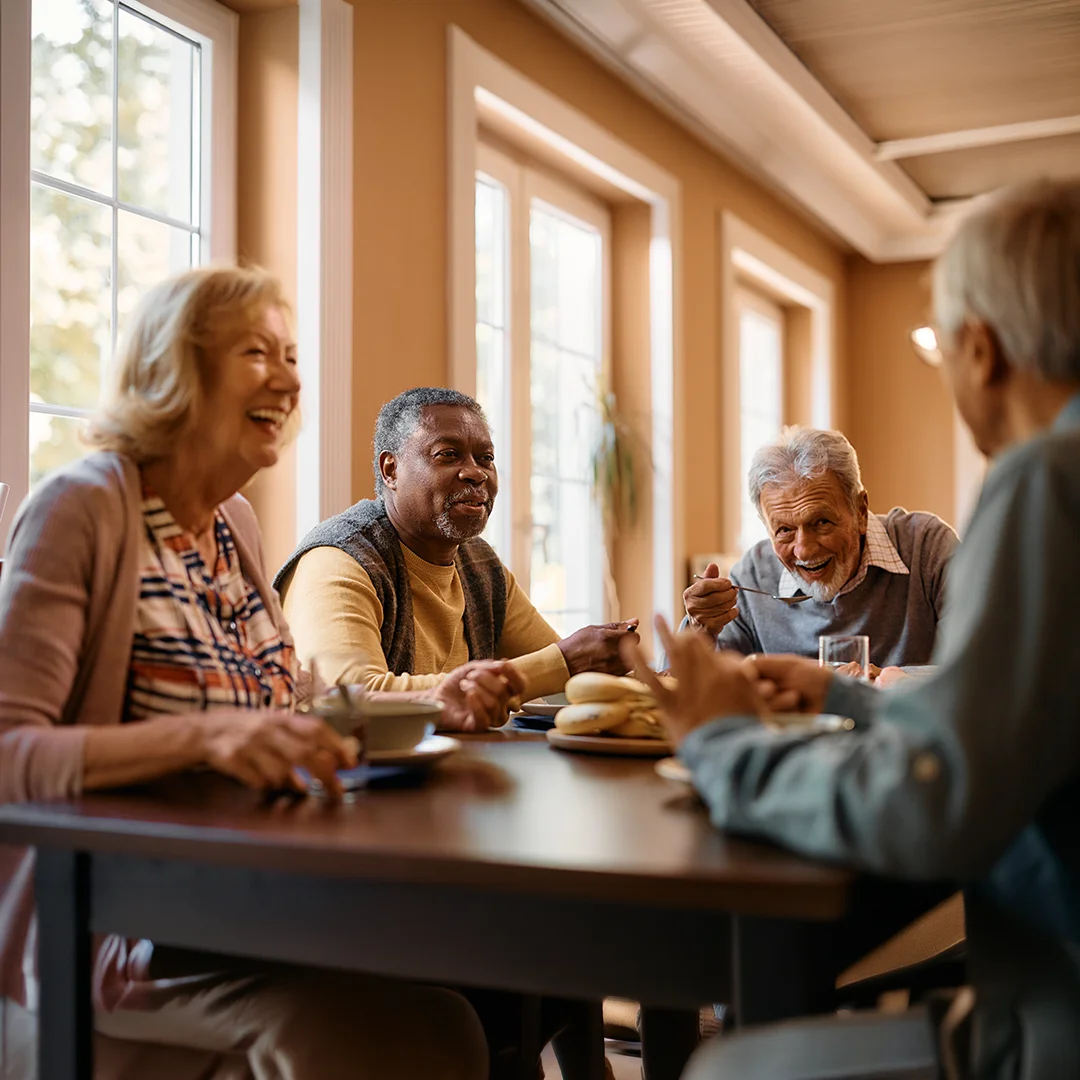 Seniors enjoying a cheerful meal together